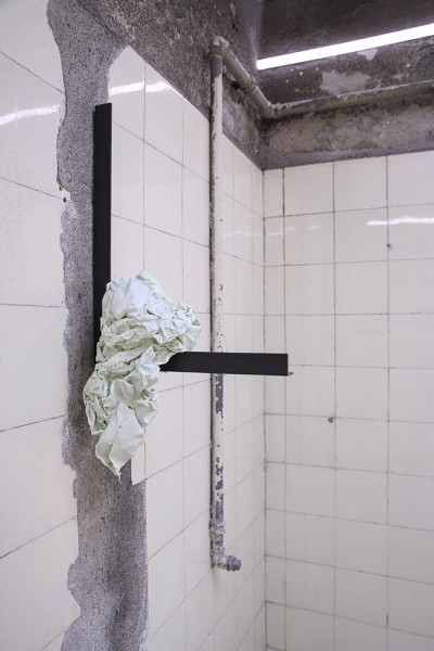 A piece of folded cloth hangs on the wall.