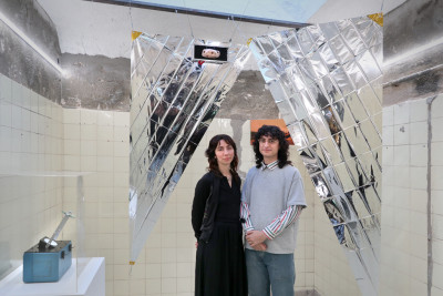 the curators staying under a solar sail made from rescue blakets