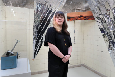 The artist in front of their artwork