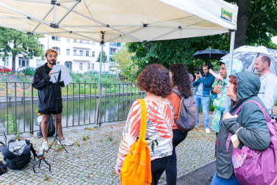 Life Performance.  The visitors listen to the speaker. Diren Demir: Speak to the Water, 2022